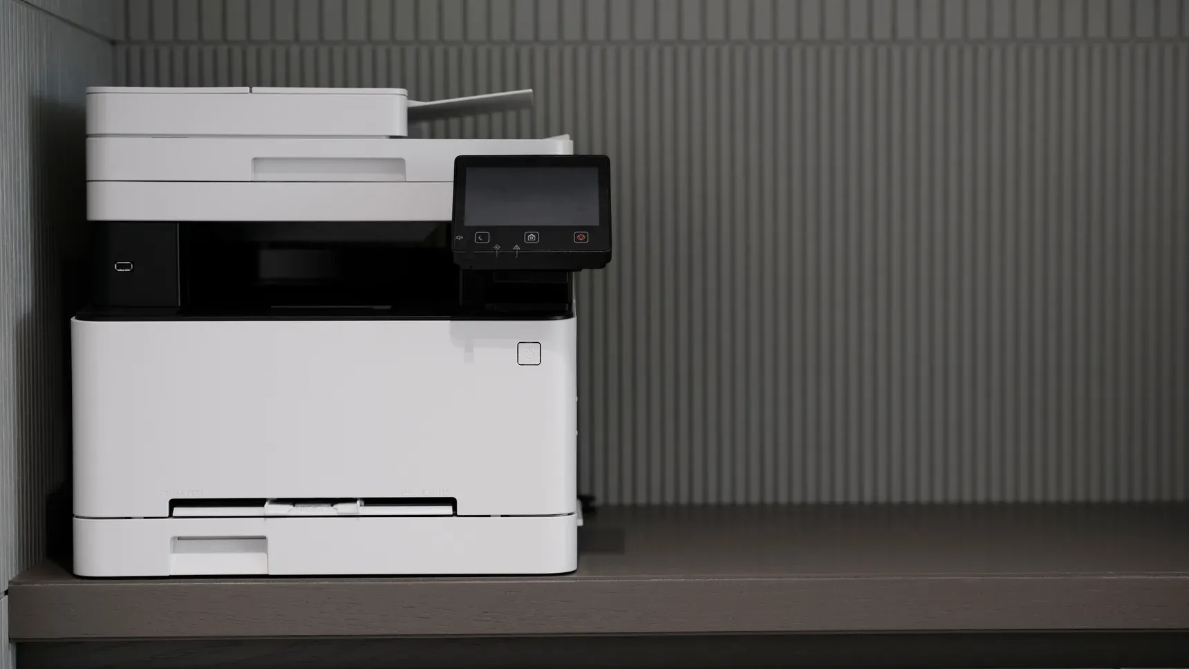 A printer with blank paper in a bright office
