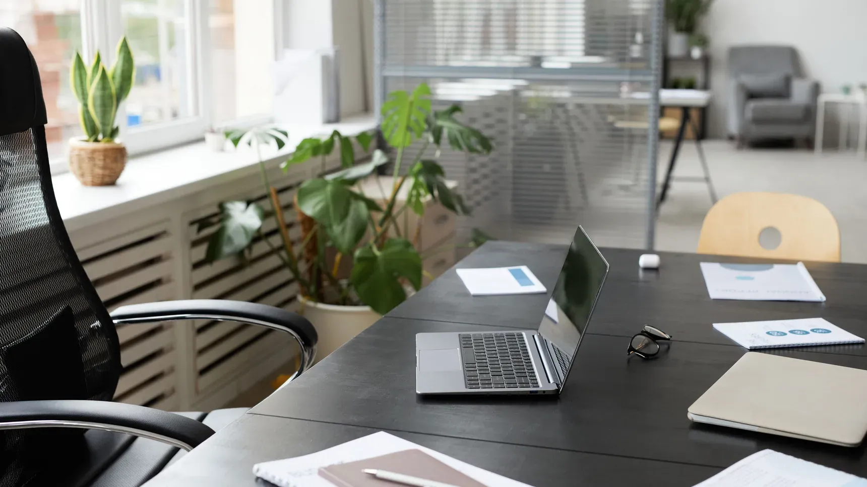 A bright office with several desks, seen in daylight