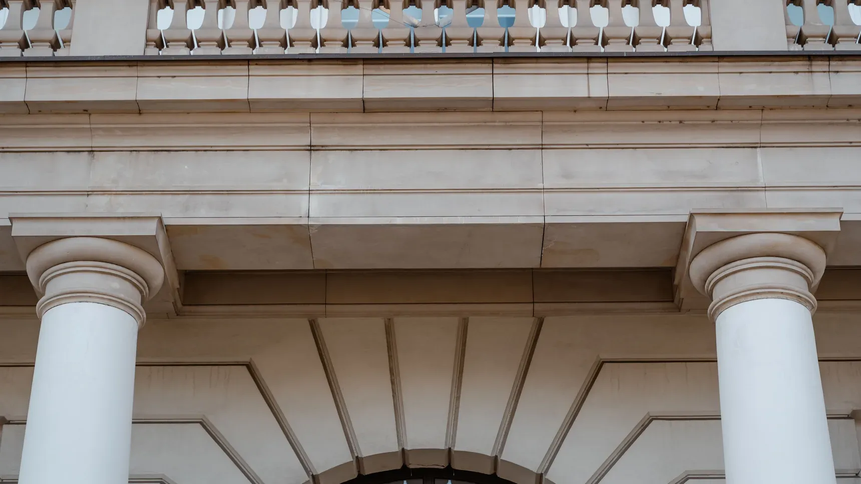Pale stone columns of a public building in daylight